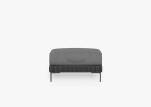 Black Wicker Outdoor Ottoman shown with the OuterShell outdoor cushion cover, offering exclusive integrated protection. #color_sandstone gray