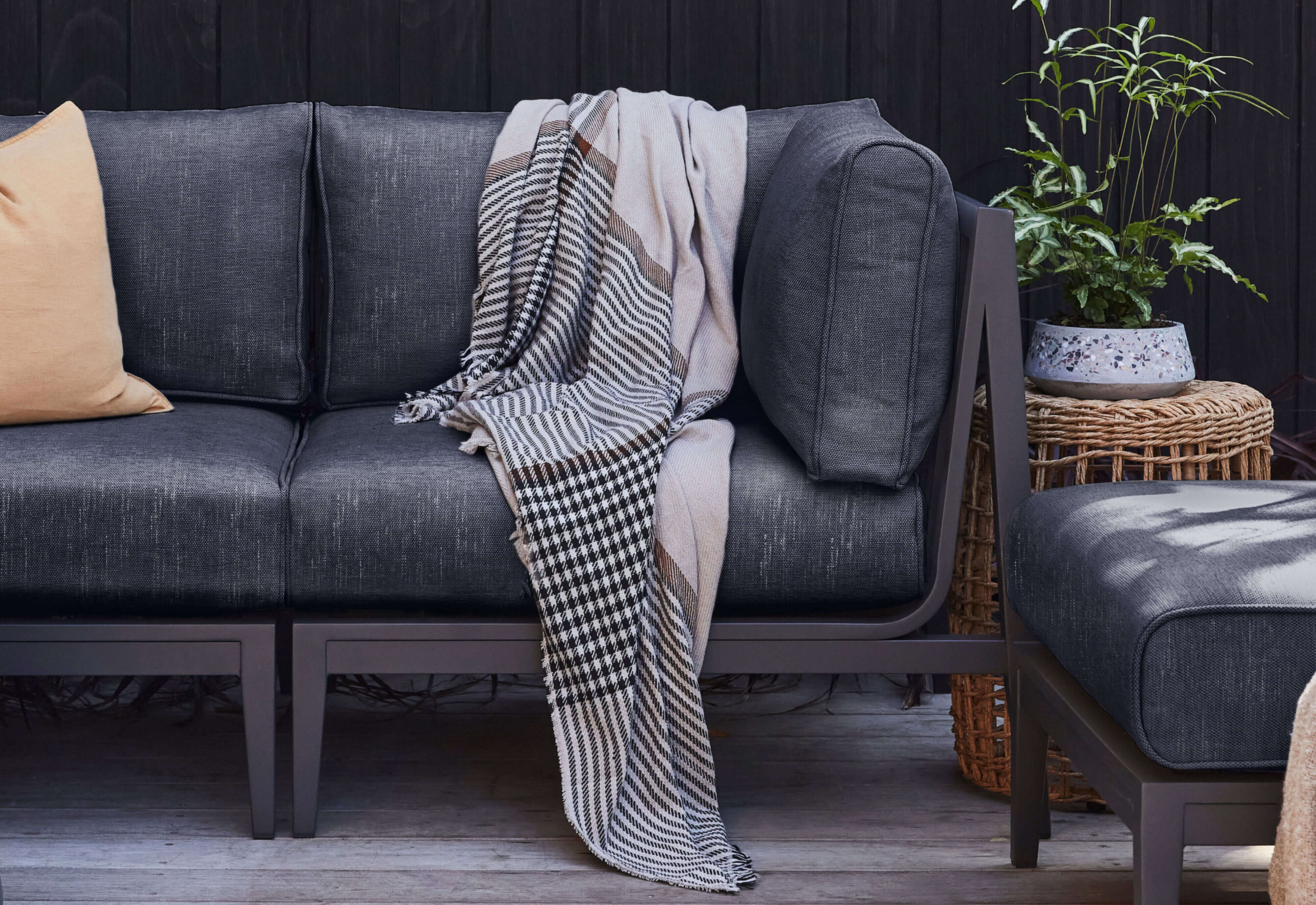 Charcoal Aluminum sofa shown with Deep Sea Navy cushions.