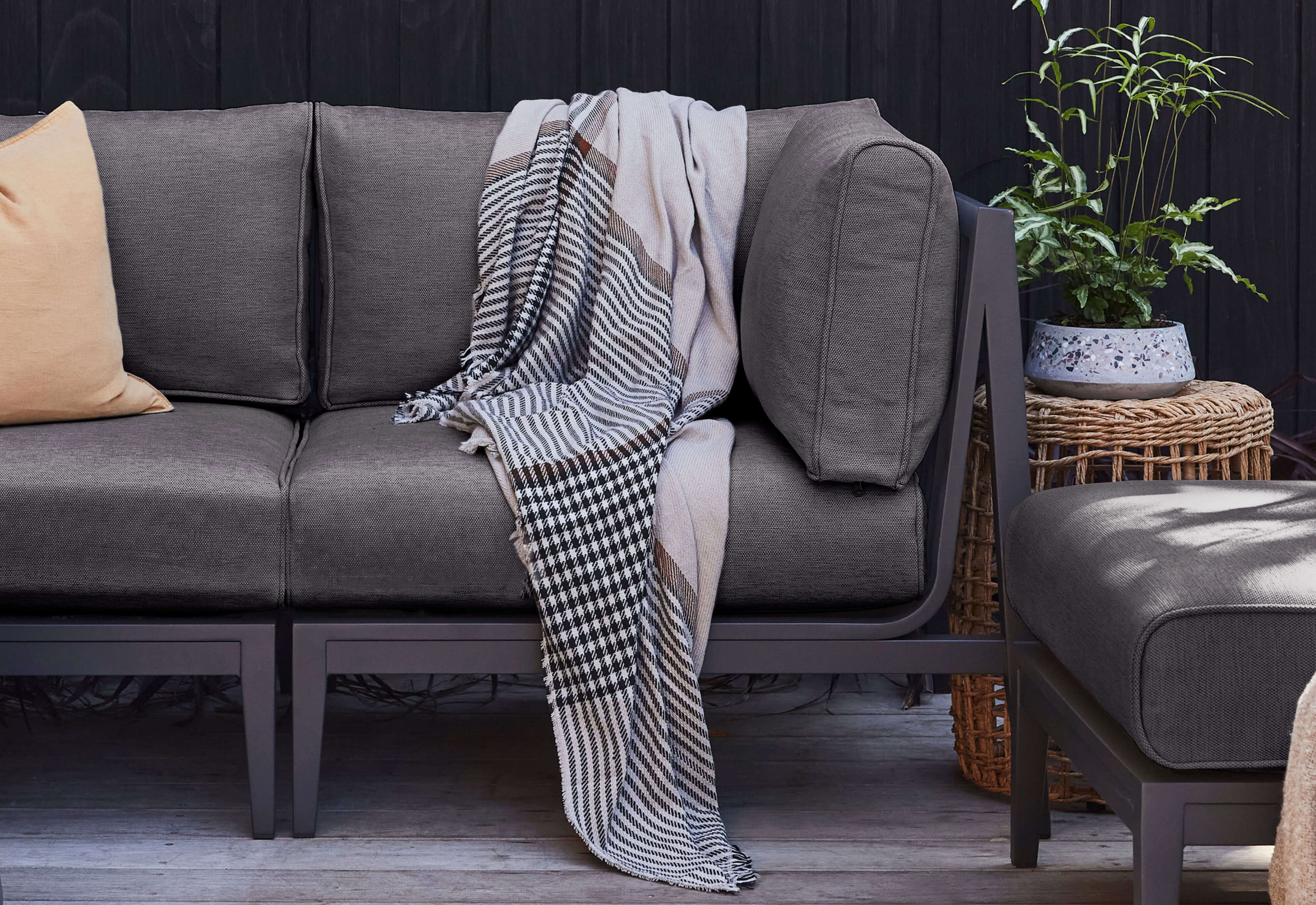 Charcoal Aluminum sofa shown with Dark Pebble Gray cushions.